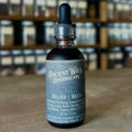 Dark glass tincture bottle with dropper, labeled Relief Belly digestive support blend from Ancient Ways Apothecary.