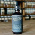 Dark amber tincture bottle labeled Rich for the Vitals with traditional Chinese herbs on wooden surface