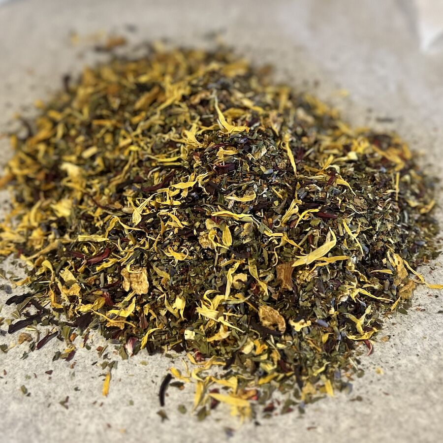 Close-up of Amidst Elegance herbal tea blend with passionflower, lemon, rooibos, and natural no caffeine ingredients
