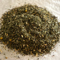 Close-up of Zen herbal tea blend with ashwagandha, chamomile, and passionflower pieces on a light textured surface