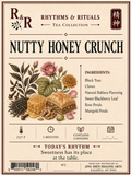 Front of a tea bag packaging label for R&R Tea Collection's Nutty Honey Crunch flavor. The label features a vintage-style illustration of a honeycomb, cloves, a pink rose, a yellow flower, and marigold petals, alongside a depiction of a layered pastry.