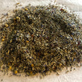 Close-up of Restful Nights loose herbal tea blend with lemongrass, peppermint, chamomile, valerian, and dried flower petals.