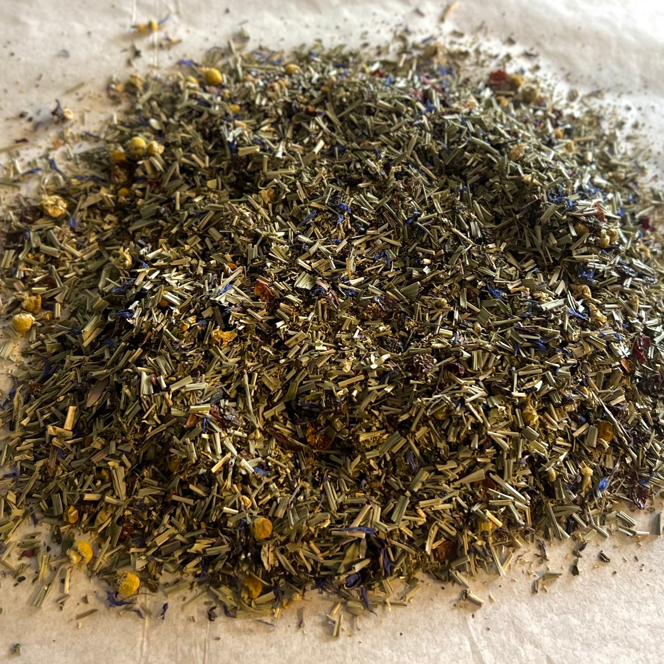 Close-up of Restful Nights loose herbal tea blend with lemongrass, peppermint, chamomile, valerian, and dried flower petals.