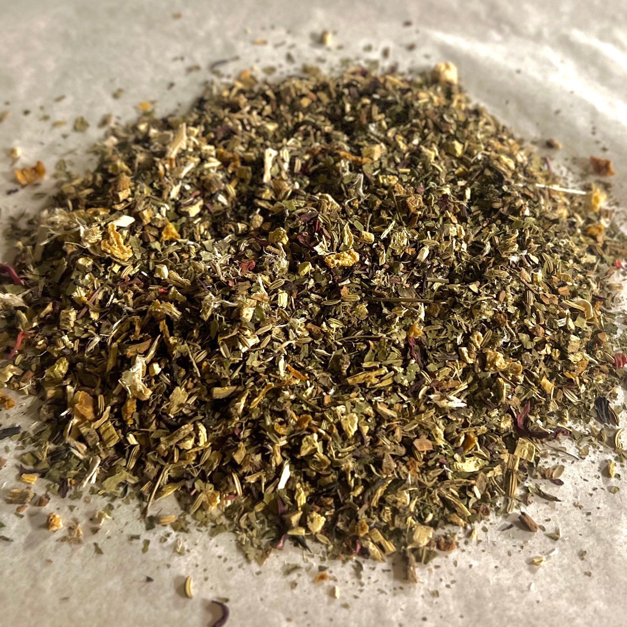 Close-up of loose Soothe Throat herbal tea blend with dried herbs and spices for natural throat relief and calming comfort