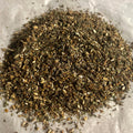 Close-up of Support | Liver loose tea blend with burdock, milk thistle, and green rooibos on a light background