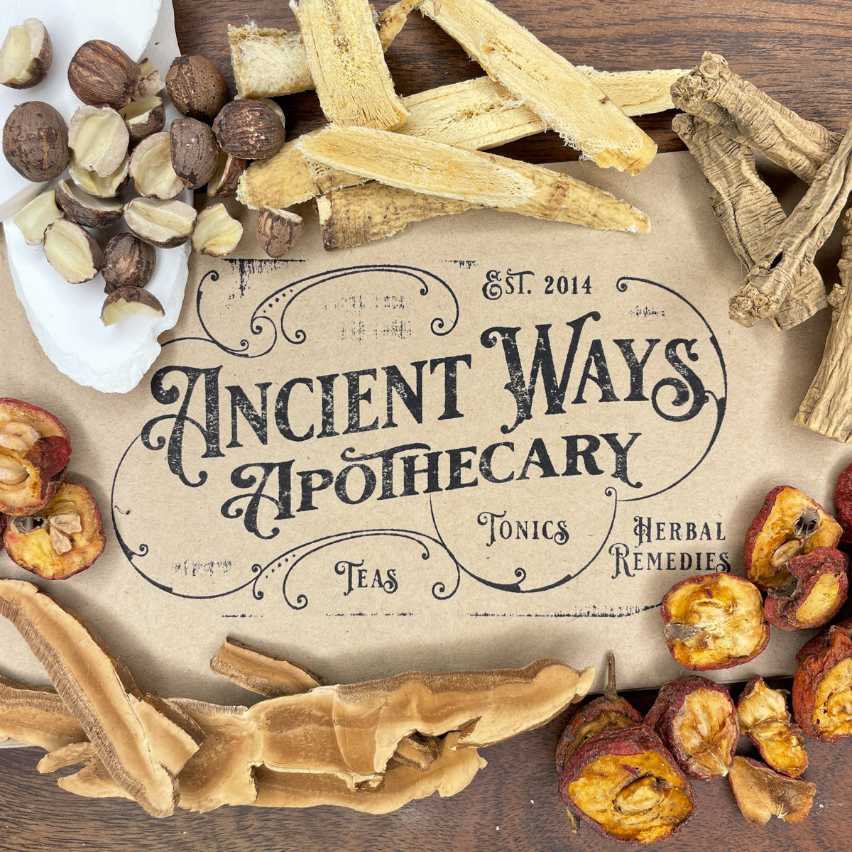 Dried Chinese herbs including roots, nuts, and fruit pieces arranged around an Ancient Ways Apothecary label on wood.